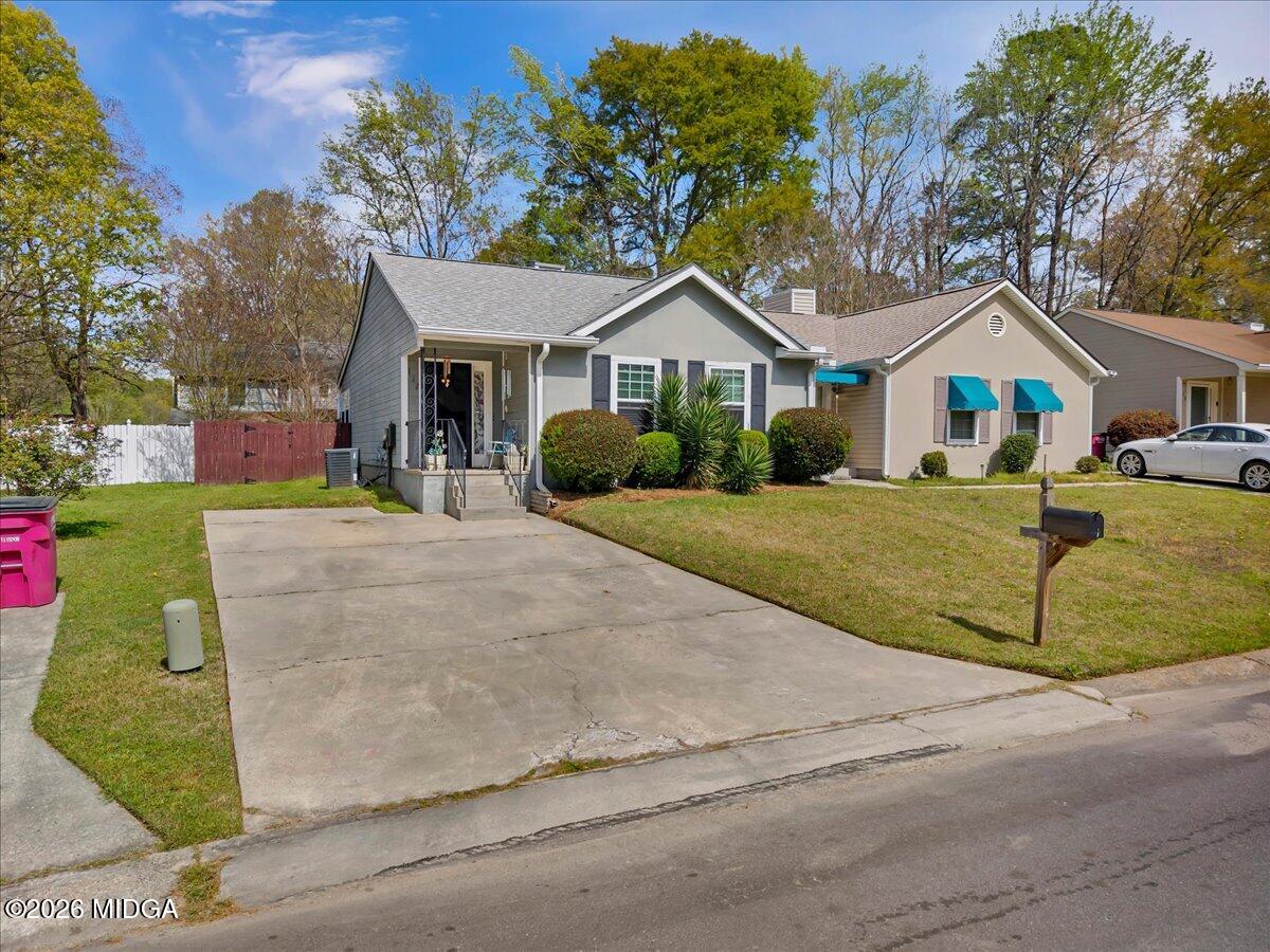 122 Wesleyan Way Macon, GA 31210 - Photo 2 of 20 a front view of a house with a yard and garage