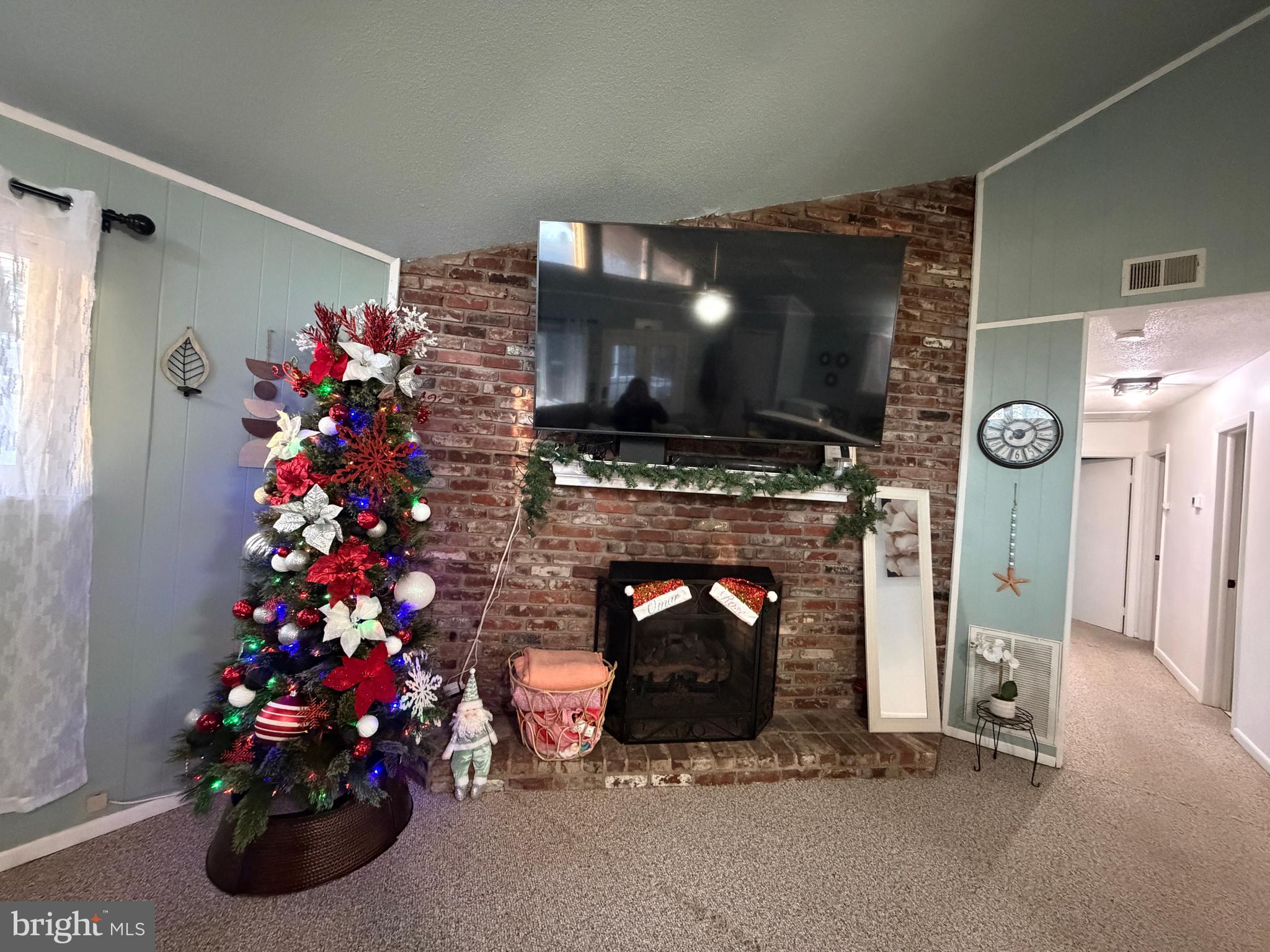 359 Straton Way Basye, VA 22842 - Photo 12 of 38 a living room with furniture a flat screen tv and a fireplace