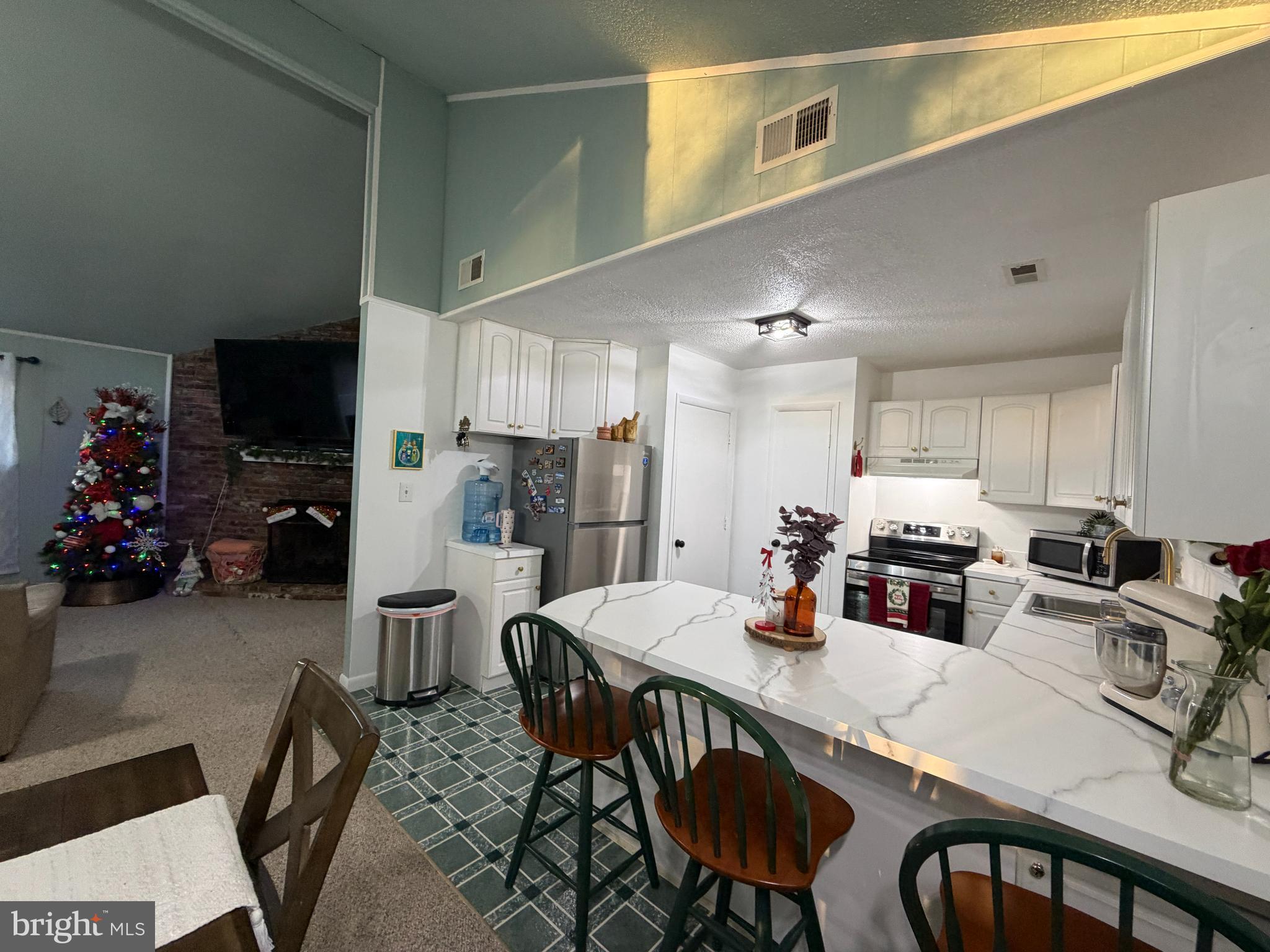 359 Straton Way Basye, VA 22842 - Photo 16 of 38 a kitchen with a table chairs and a refrigerator