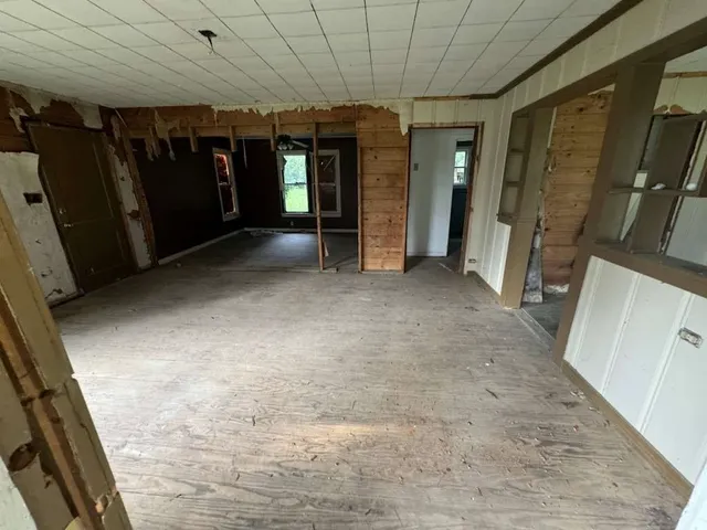 a view of a hallway with wooden shelves