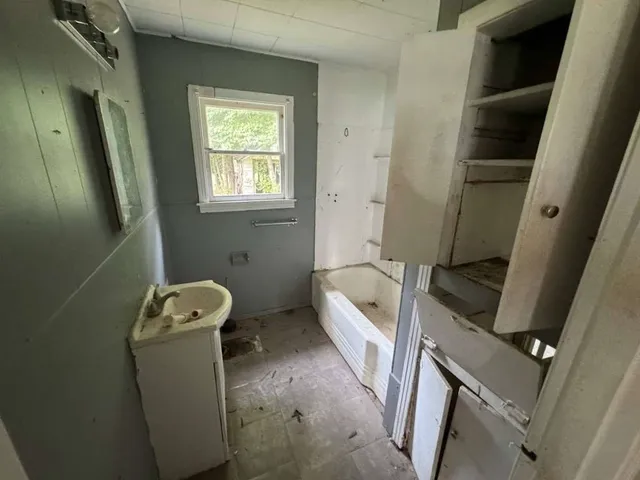 a bathroom with sink and window
