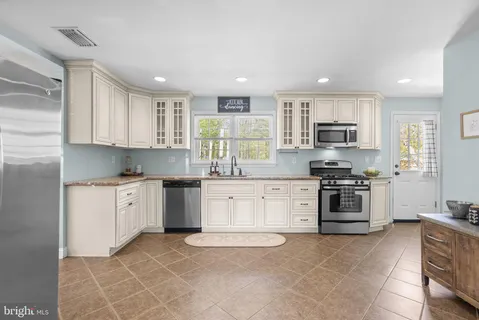 a kitchen with a stove top oven sink and cabinets
