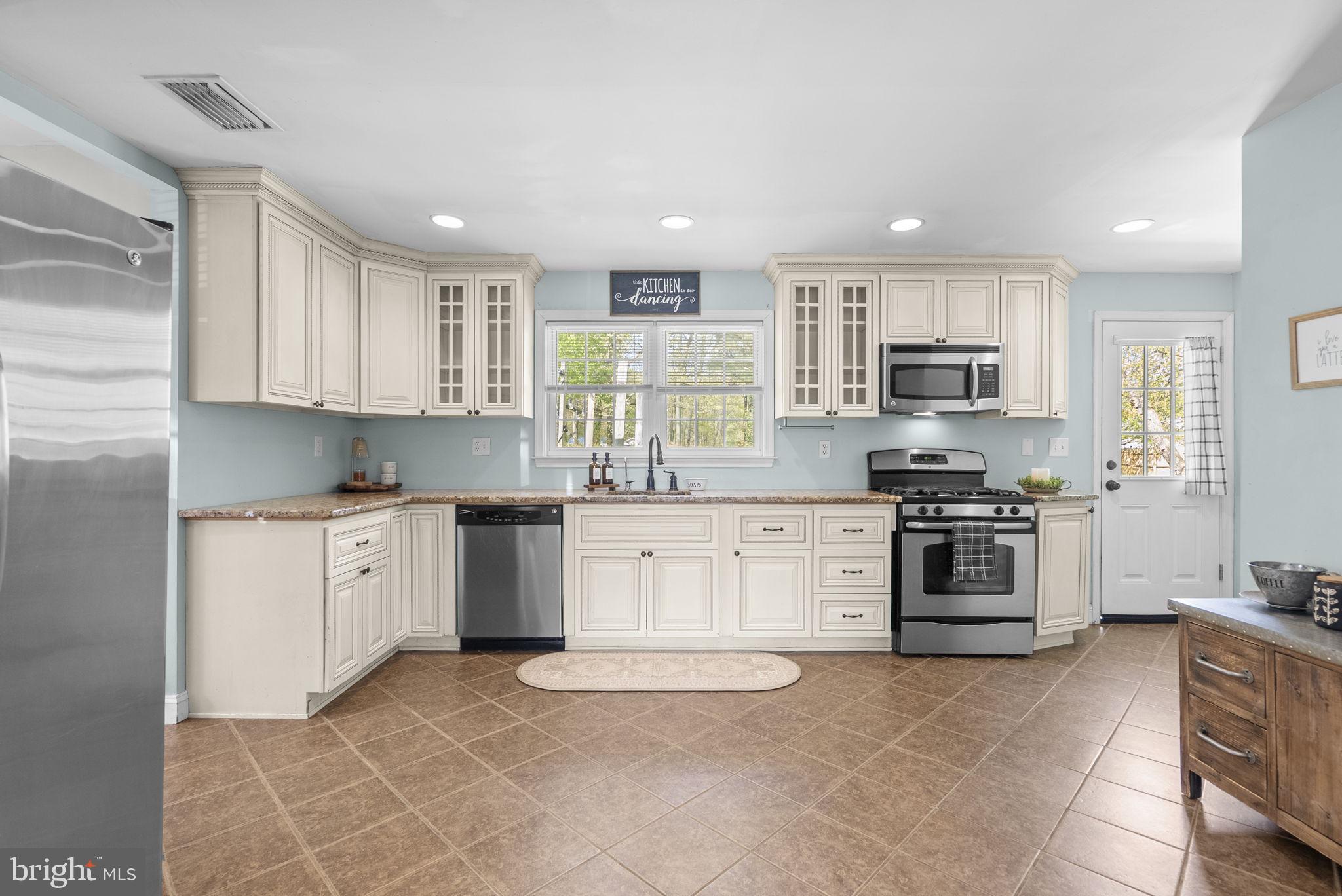 604 Perrys Corner Road Grasonville, MD 21638 - Photo 12 of 32 a kitchen with a stove top oven sink and cabinets