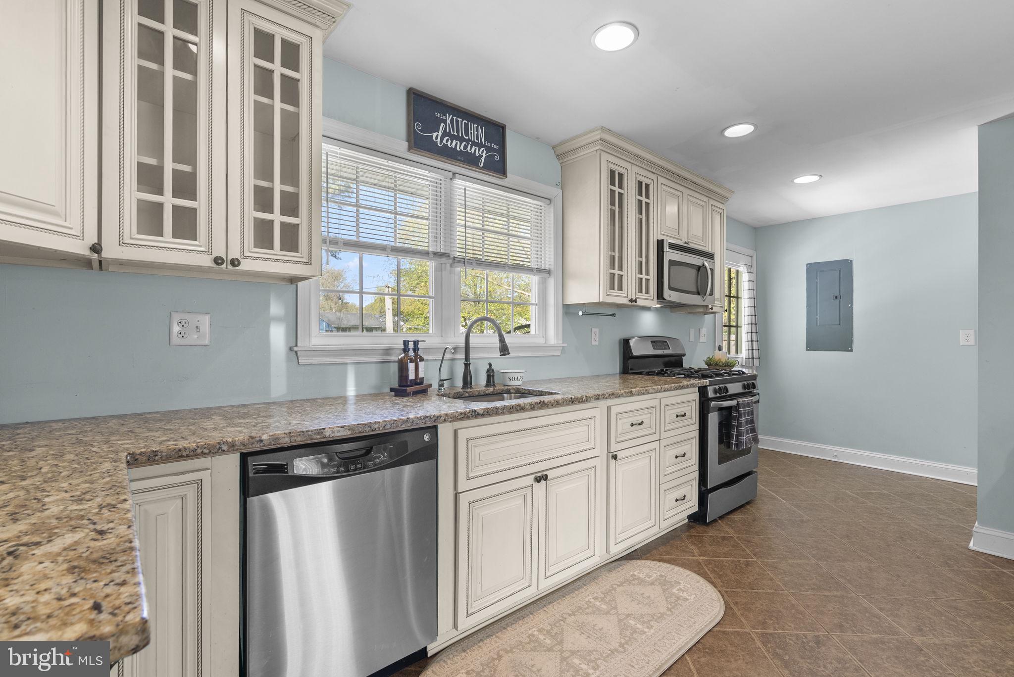 604 Perrys Corner Road Grasonville, MD 21638 - Photo 13 of 32 a kitchen with stainless steel appliances granite countertop a sink stove and cabinets
