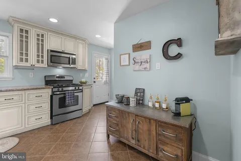 a kitchen with stainless steel appliances granite countertop a stove and a sink