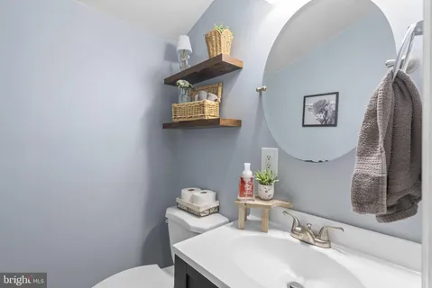 a bathroom with a sink mirror and toilet