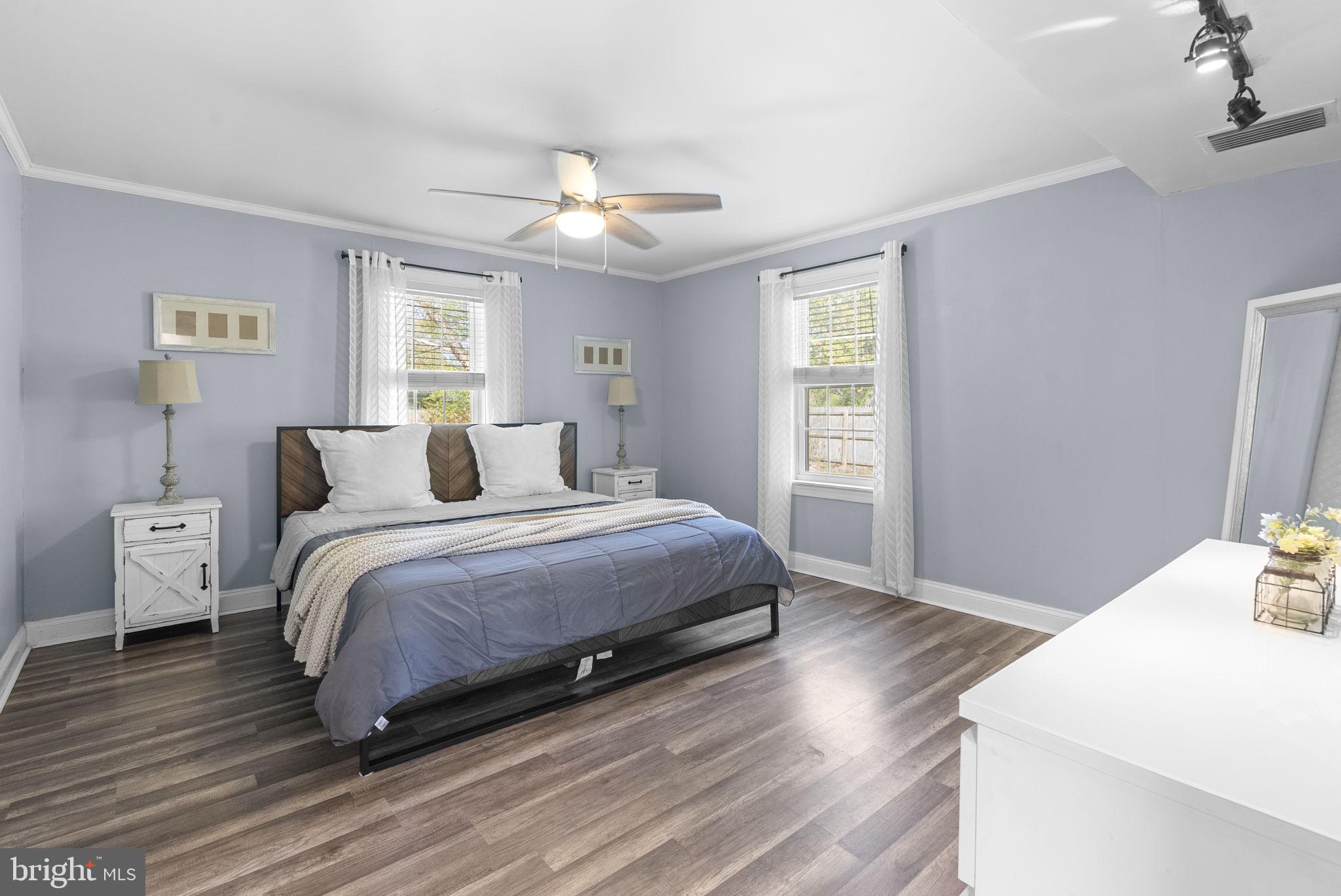 604 Perrys Corner Road Grasonville, MD 21638 - Photo 21 of 32 a bedroom with a bed and wooden floor