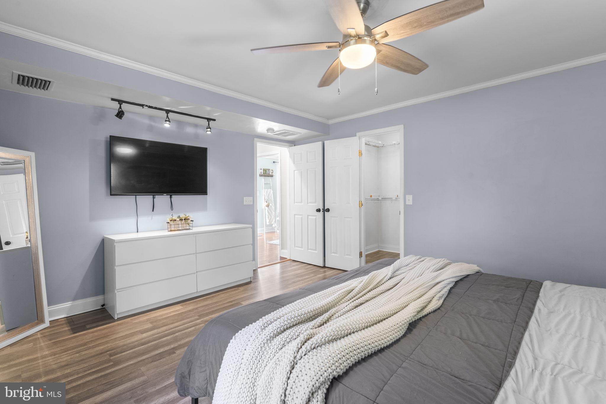 604 Perrys Corner Road Grasonville, MD 21638 - Photo 22 of 32 a bedroom with a bed and a flat screen tv