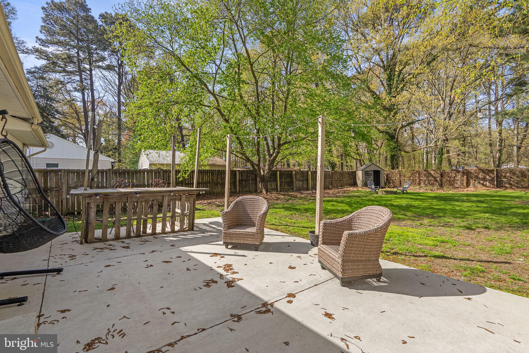 604 Perrys Corner Road Grasonville, MD 21638 - Photo 24 of 32 a view of a patio with a table chairs and a garden