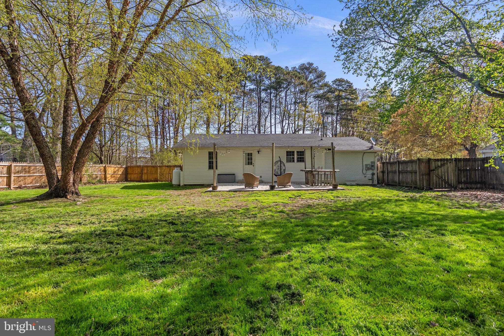 604 Perrys Corner Road Grasonville, MD 21638 - Photo 25 of 32 a front view of a house with a yard table and chairs