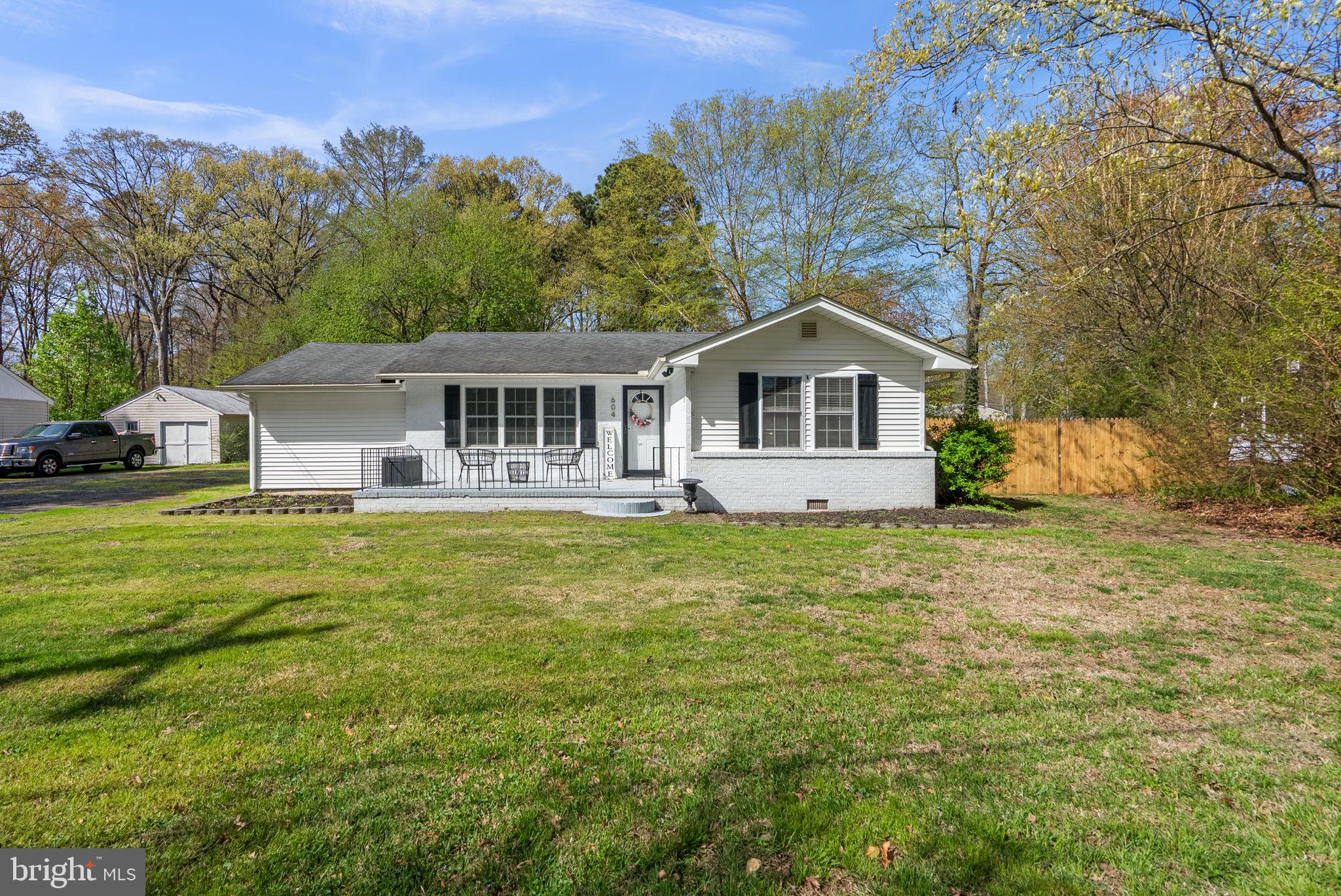 604 Perrys Corner Road Grasonville, MD 21638 - Photo 3 of 32 a front view of a house with a garden and trees