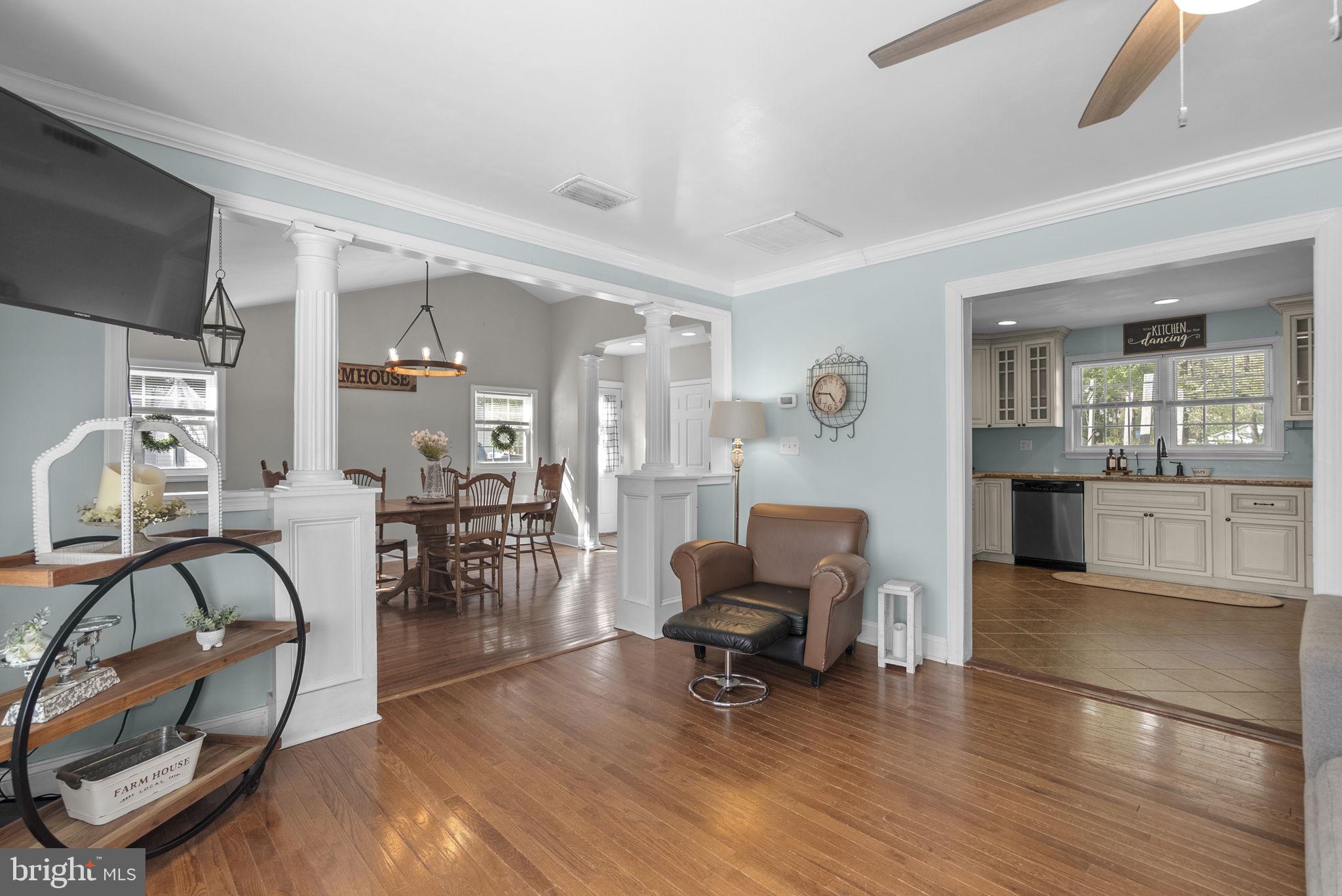 604 Perrys Corner Road Grasonville, MD 21638 - Photo 7 of 32 a living room with furniture and a dining table with kitchen view