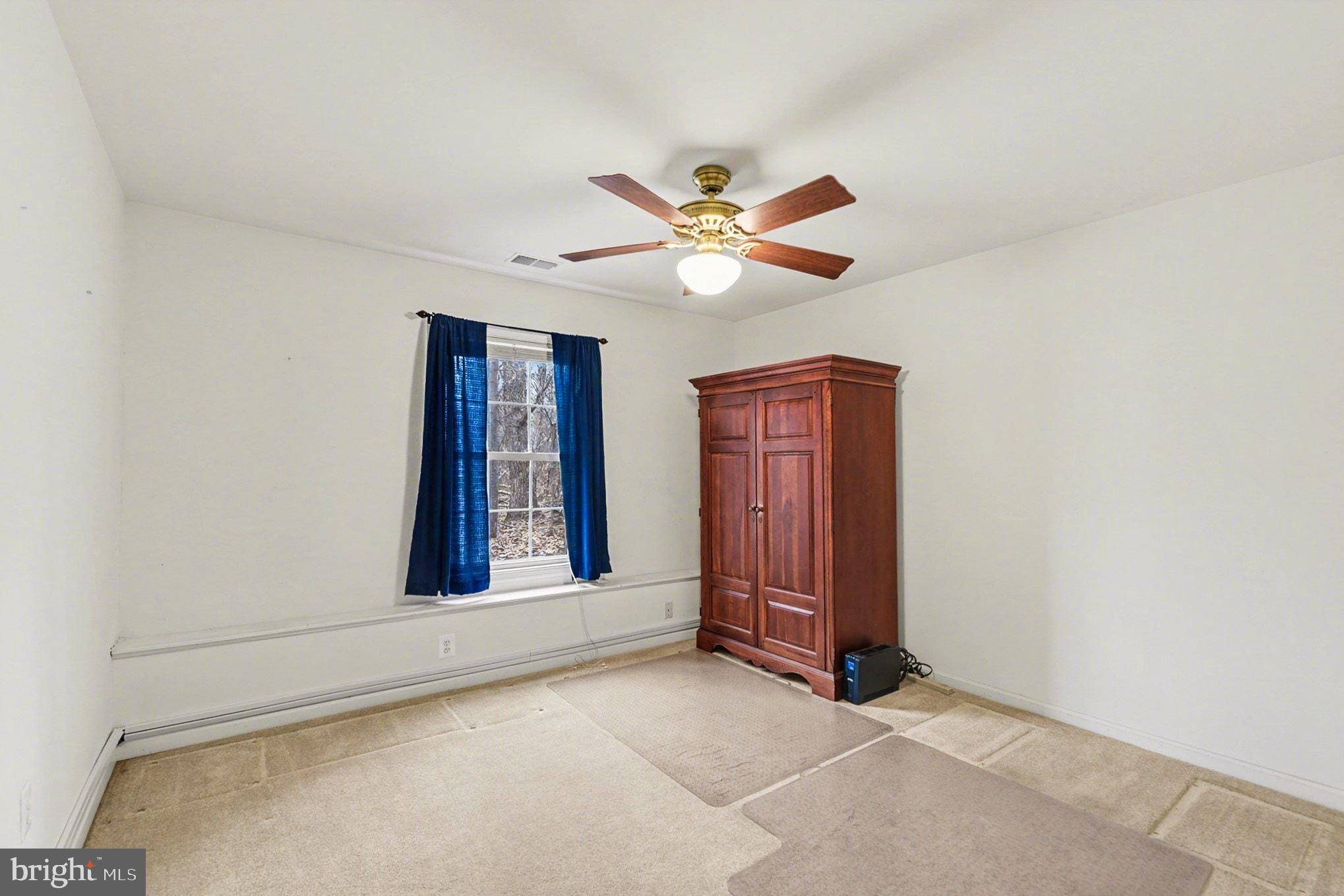 1645 Timber Summit Drive Westminster, MD 21157 - Photo 35 of 65 an empty room with windows and ceiling fan