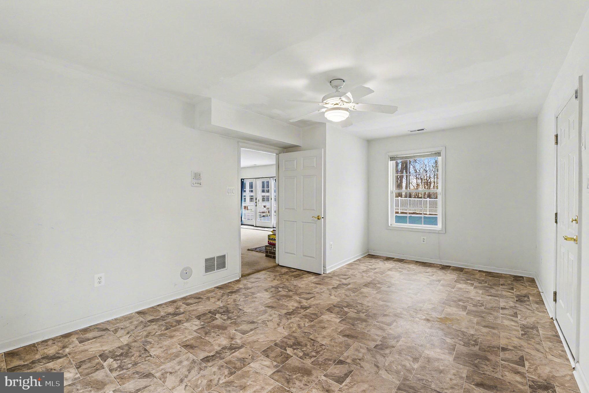 1645 Timber Summit Drive Westminster, MD 21157 - Photo 36 of 65 an empty room with windows and fan