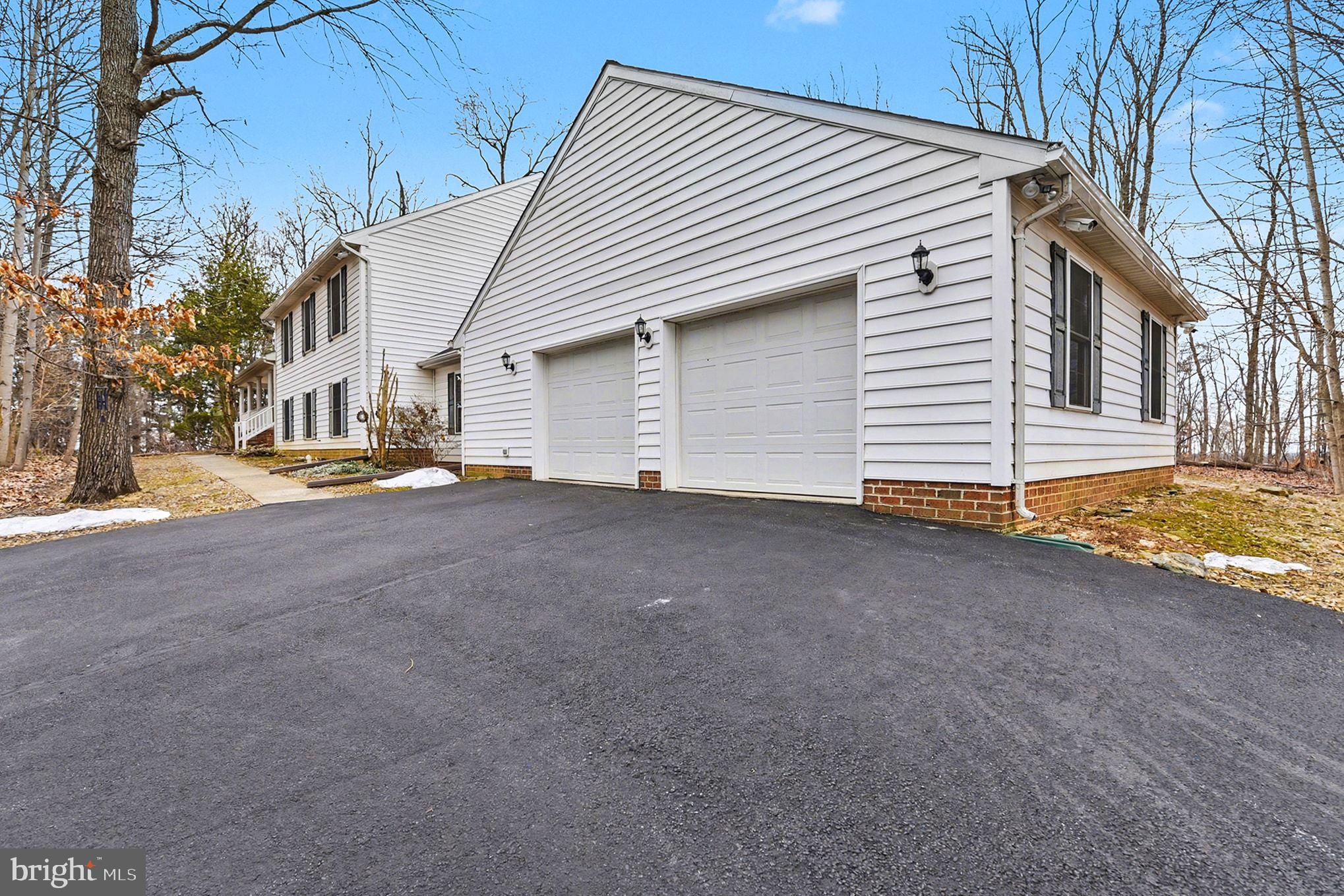 1645 Timber Summit Drive Westminster, MD 21157 - Photo 4 of 65 a view of a house with a yard and garage