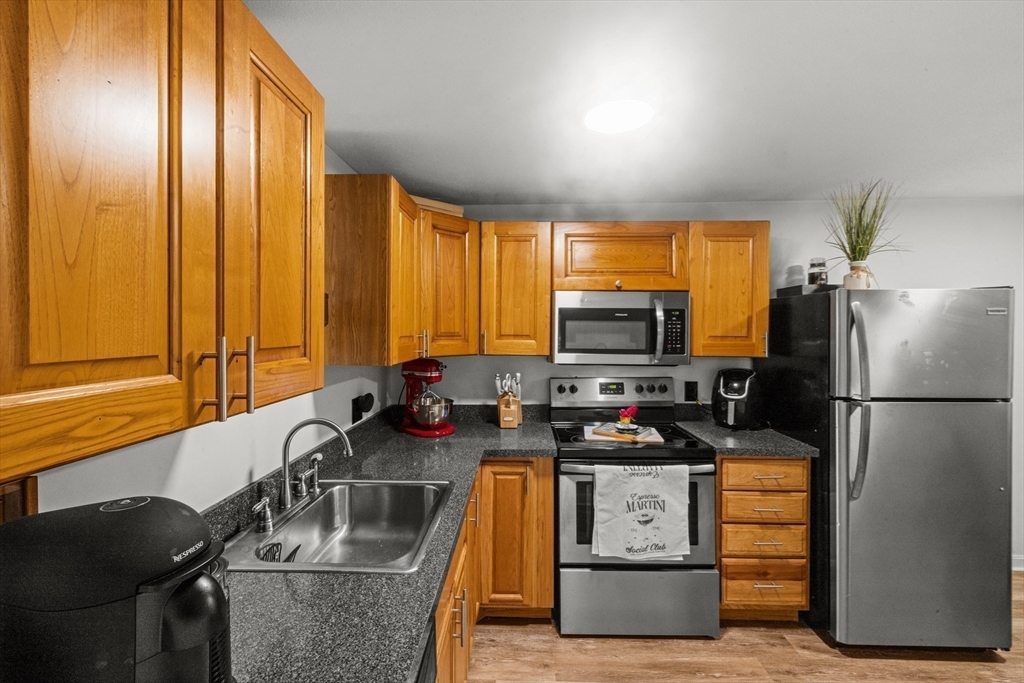 1619 Braley Road, Unit 97 New Bedford, MA 02745 - Photo 11 of 27 a kitchen with appliances a sink and cabinets
