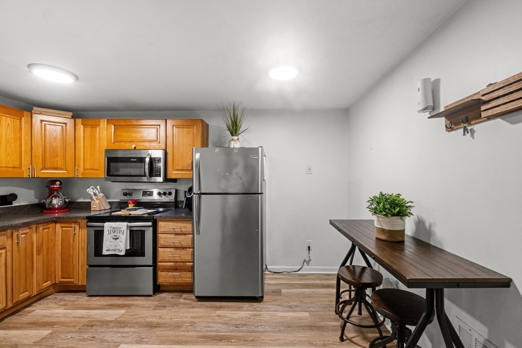 1619 Braley Road, Unit 97 New Bedford, MA 02745 - Photo 12 of 27 a kitchen with stainless steel appliances a refrigerator and a stove top oven