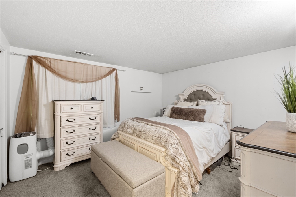 1619 Braley Road, Unit 97 New Bedford, MA 02745 - Photo 15 of 27 a bedroom with a bed and a cabinets