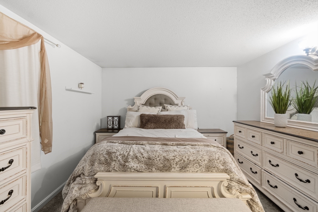 1619 Braley Road, Unit 97 New Bedford, MA 02745 - Photo 16 of 27 a bedroom with a bed and a dresser