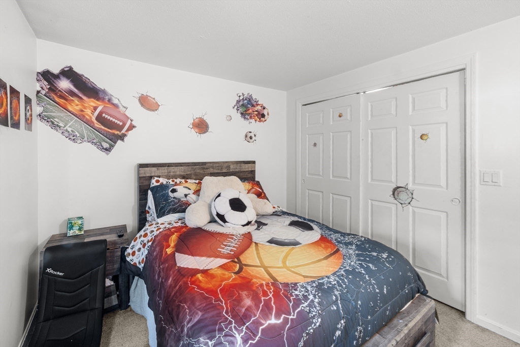 1619 Braley Road, Unit 97 New Bedford, MA 02745 - Photo 19 of 27 a bedroom with a bed and a painting on the wall