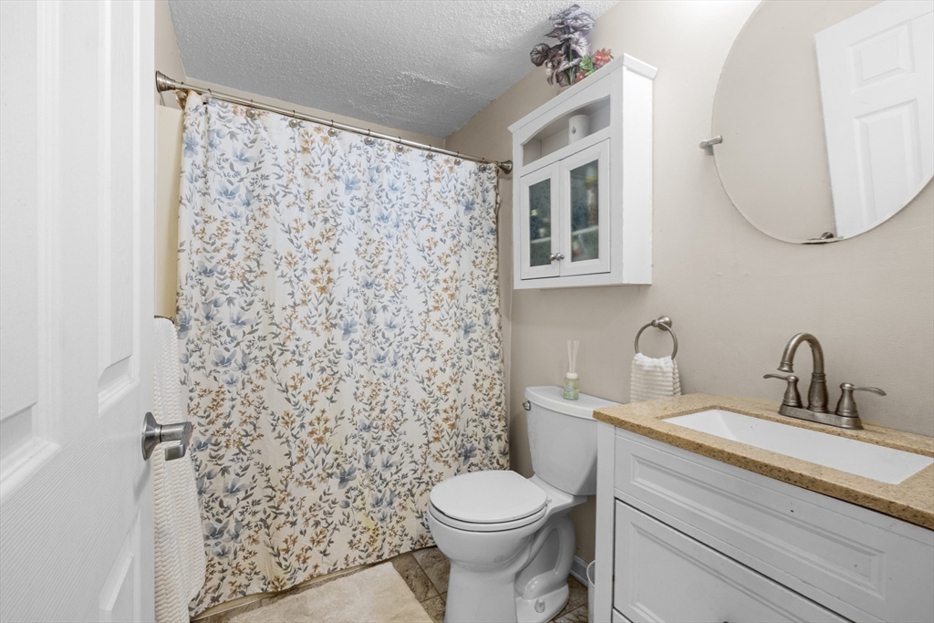 1619 Braley Road, Unit 97 New Bedford, MA 02745 - Photo 20 of 27 a bathroom with a sink a toilet and a mirror