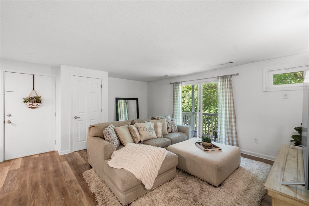 1619 Braley Road, Unit 97 New Bedford, MA 02745 - Photo 3 of 27 a spacious bedroom with a bed and a couch