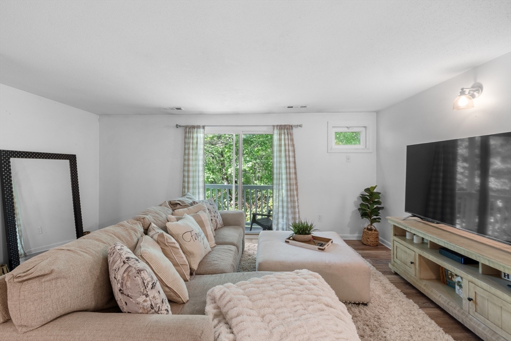 1619 Braley Road, Unit 97 New Bedford, MA 02745 - Photo 5 of 27 a living room with furniture and a flat screen tv