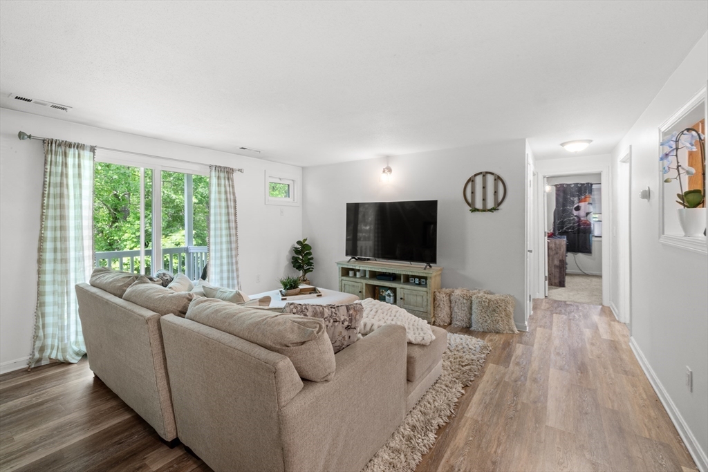 1619 Braley Road, Unit 97 New Bedford, MA 02745 - Photo 6 of 27 a living room with furniture and a flat screen tv