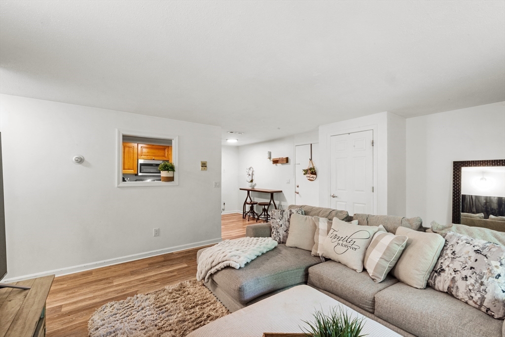 1619 Braley Road, Unit 97 New Bedford, MA 02745 - Photo 7 of 27 a living room with furniture and a couch