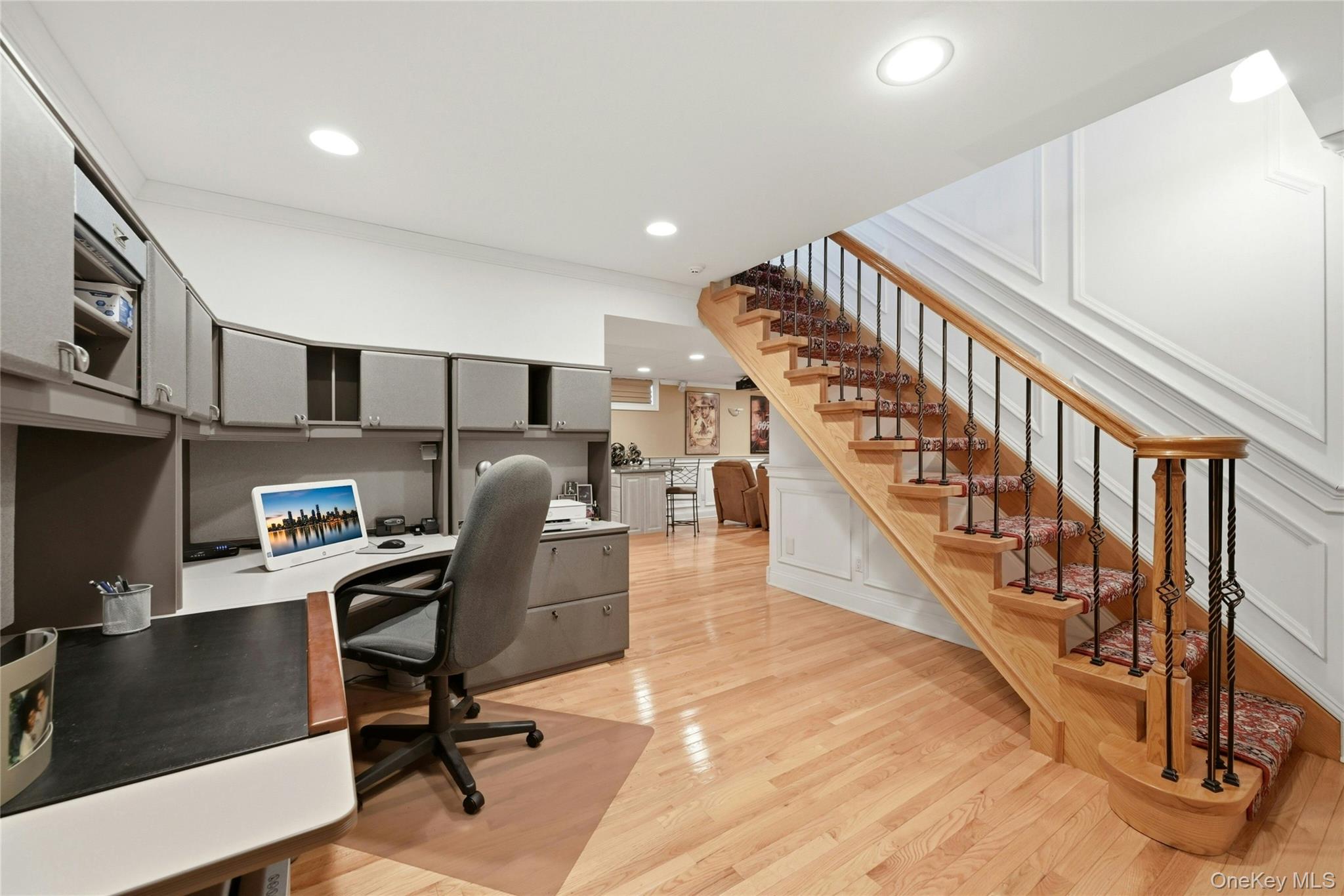 6 Thunder Road Miller Place, NY 11764 - Photo 33 of 50 The Stunning Open Stairway Also Leads To The Lower Level Which Begins With A Perfect Home Office Offering Lots Of Space For A Desk And File/Storage Cabinetry, Has Stunning Box Paneled/Wainscoted Walls, Beautiful Hardwood Floors, Recessed Lighting, And Opens Into The Spectacular Media Room & Recreation Space.