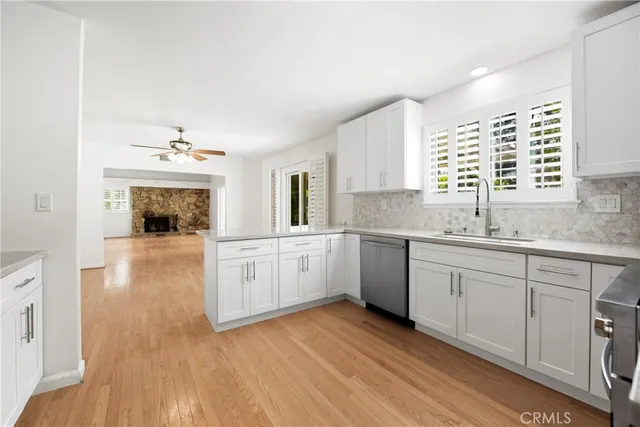a kitchen with a sink cabinets and window