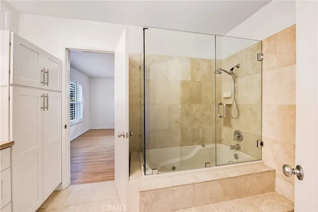 a bathroom with a glass shower door