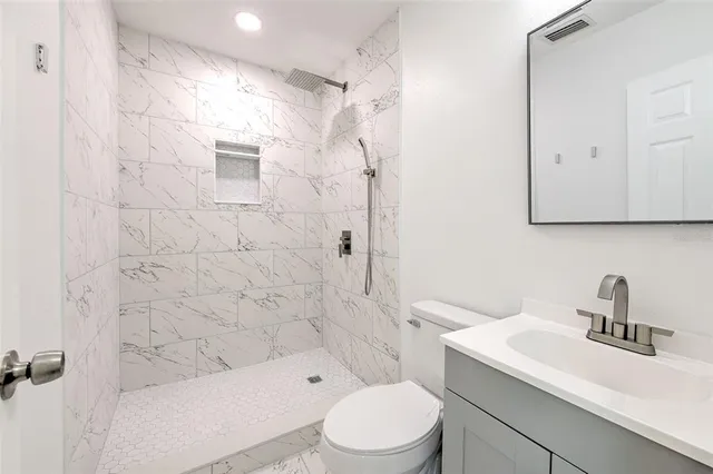 a bathroom with a sink toilet and shower