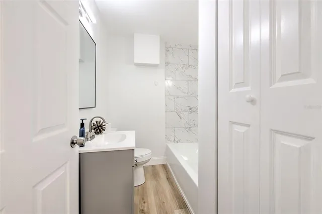 a bathroom with a sink a mirror and a bathtub