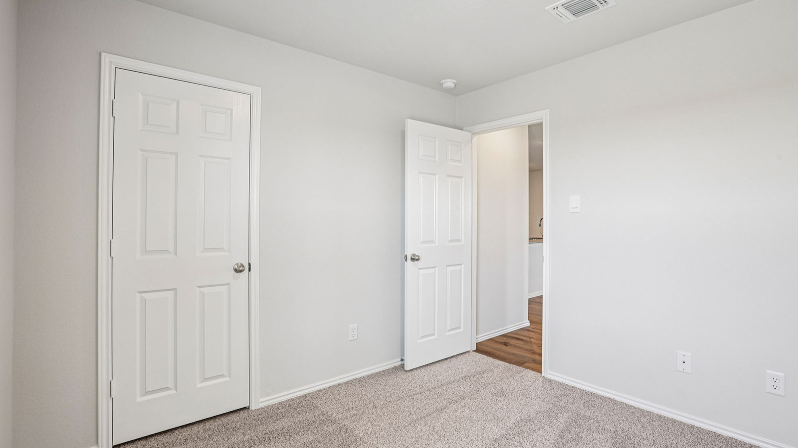 148 Wyatt Way Jarrell, TX 76537 - Photo 25 of 33 Carpeted room featuring light gray walls, white trim, and a six-panel interior door
