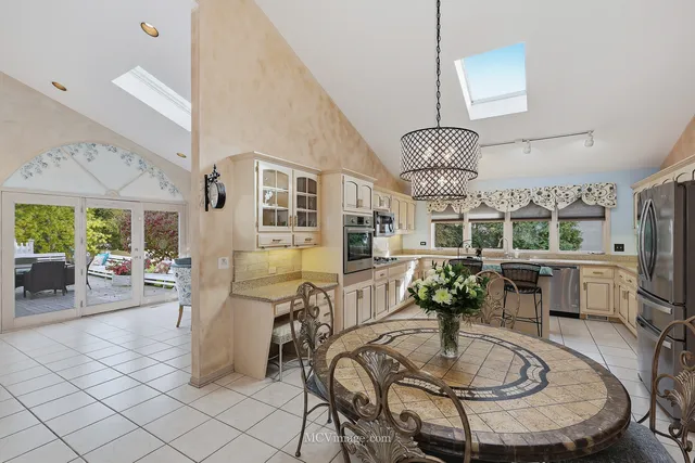 a kitchen with stainless steel appliances granite countertop a sink a stove counter space and cabinets