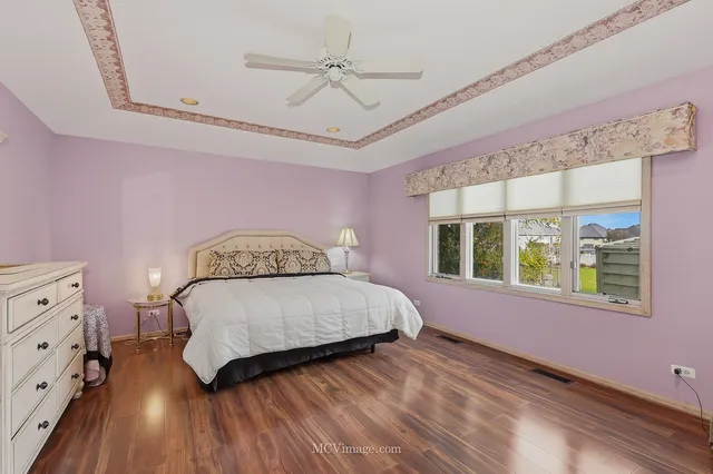 a bedroom with a dresser and a flat screen tv
