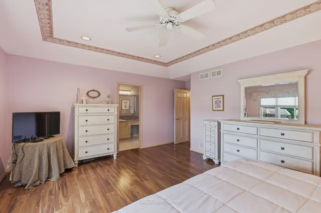 a bathroom with a granite countertop sink a mirror and a shower