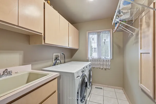 a view of an empty room with wooden floor and furniture