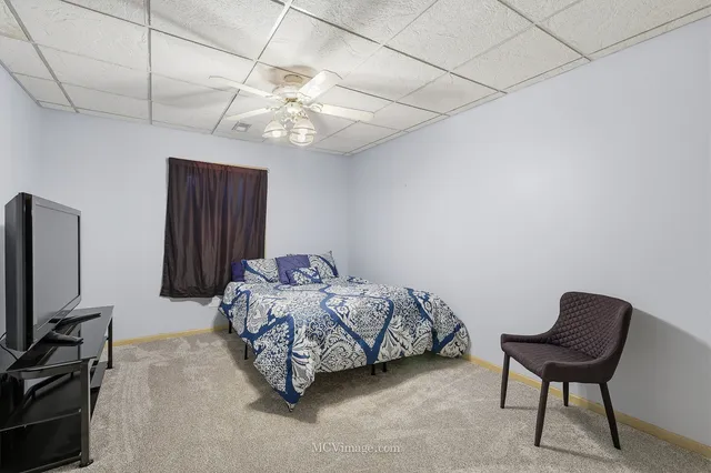 a bathroom with a granite countertop sink a toilet and a mirror