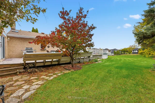 an aerial view of a house with swimming pool and outdoor space