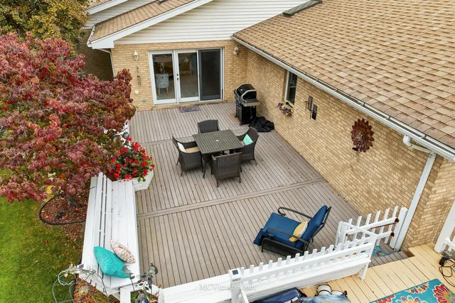 a view of a patio with couches table and chairs and potted plants