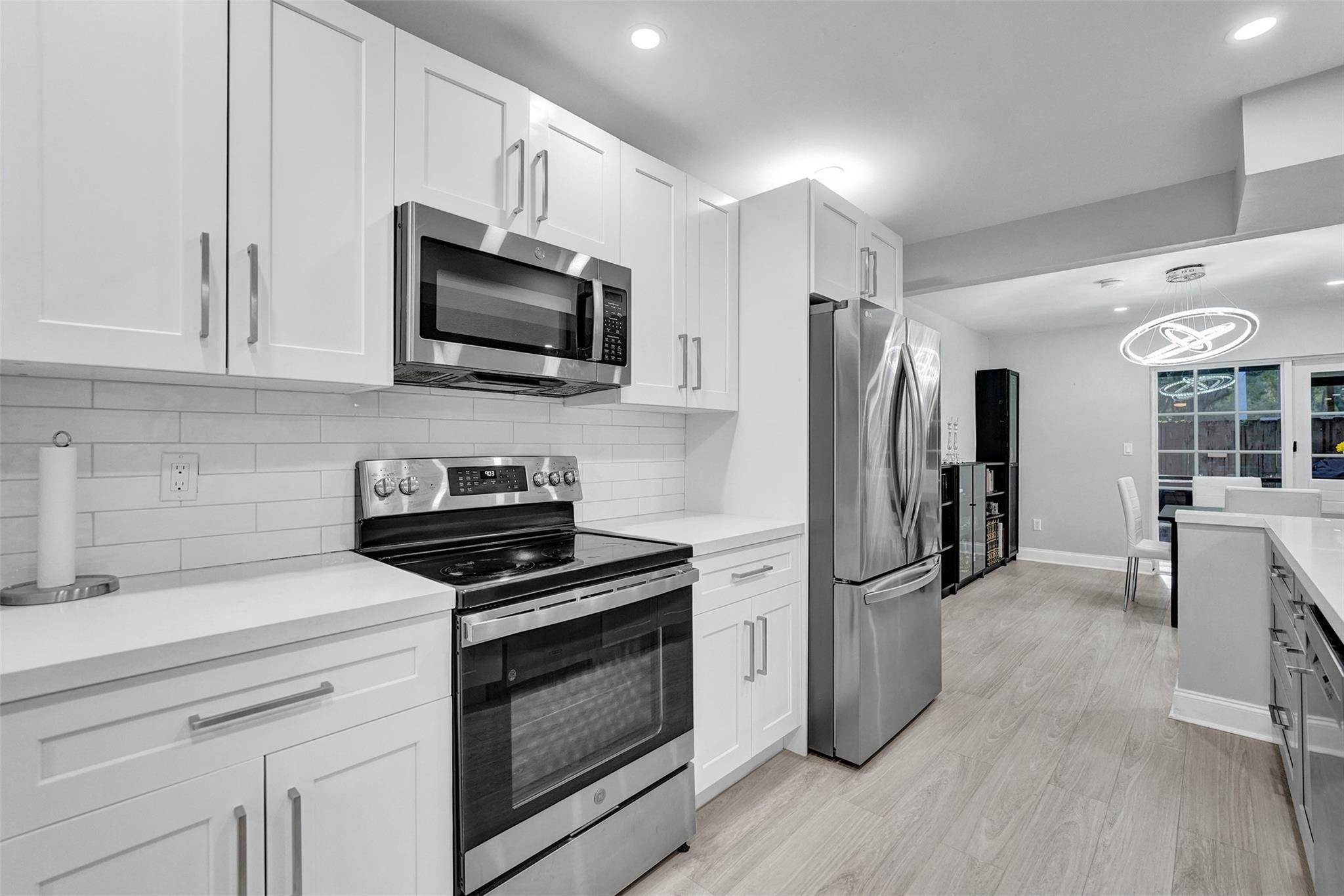 3301 Raleigh Street, Unit 4B Hollywood, FL 33021 - Photo 11 of 54 a kitchen with granite countertop a refrigerator stove and microwave