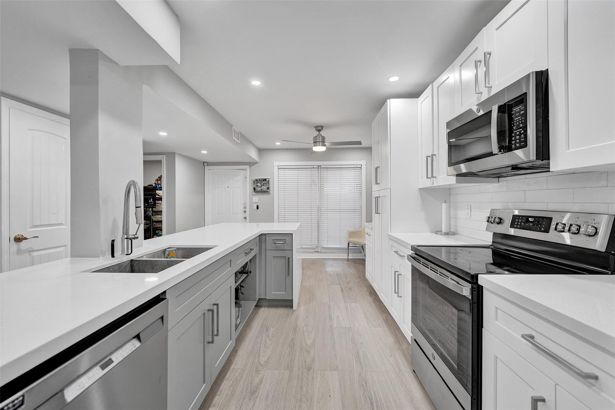 3301 Raleigh Street, Unit 4B Hollywood, FL 33021 - Photo 13 of 54 a large kitchen with stainless steel appliances granite countertop a lot of counter space and wooden floor