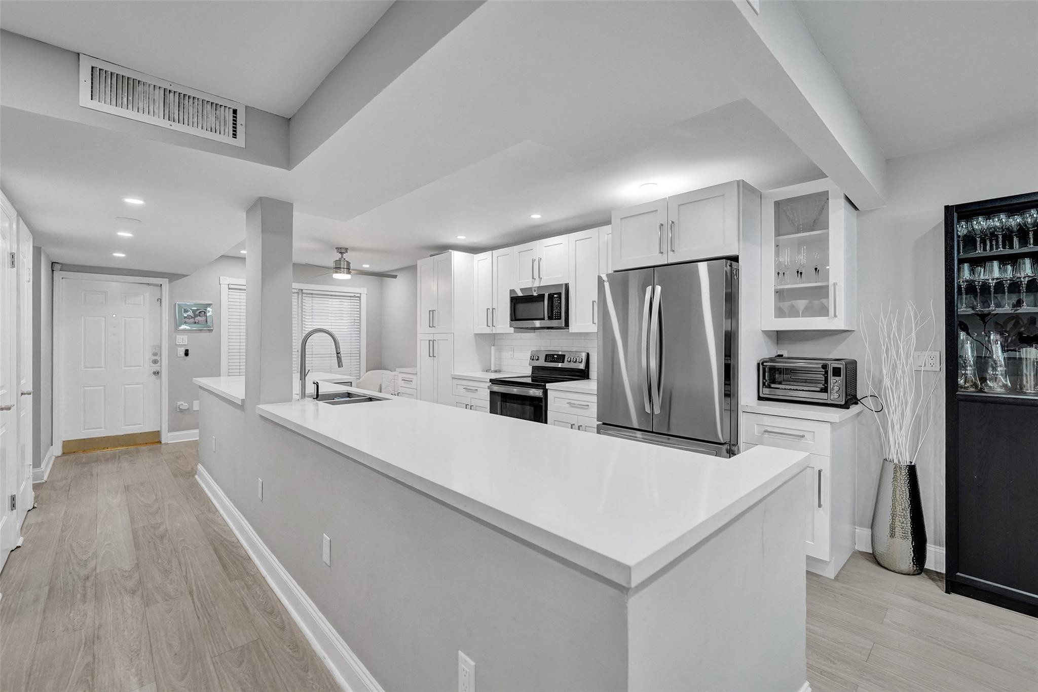 3301 Raleigh Street, Unit 4B Hollywood, FL 33021 - Photo 14 of 54 a large kitchen with a center island stainless steel appliances cabinets a sink and a counter top space