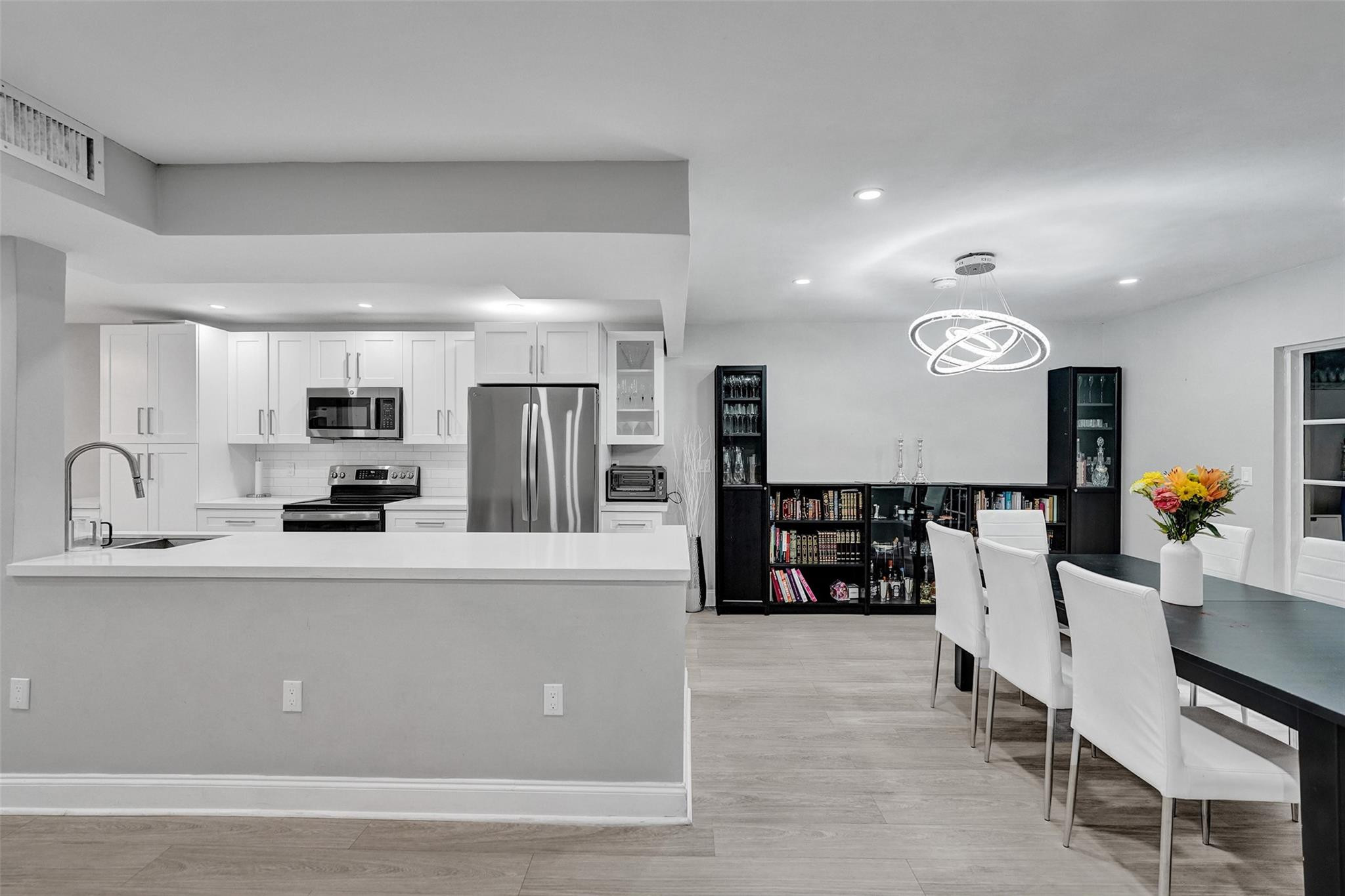 3301 Raleigh Street, Unit 4B Hollywood, FL 33021 - Photo 16 of 54 a large kitchen with stainless steel appliances a large counter top and a stove top oven