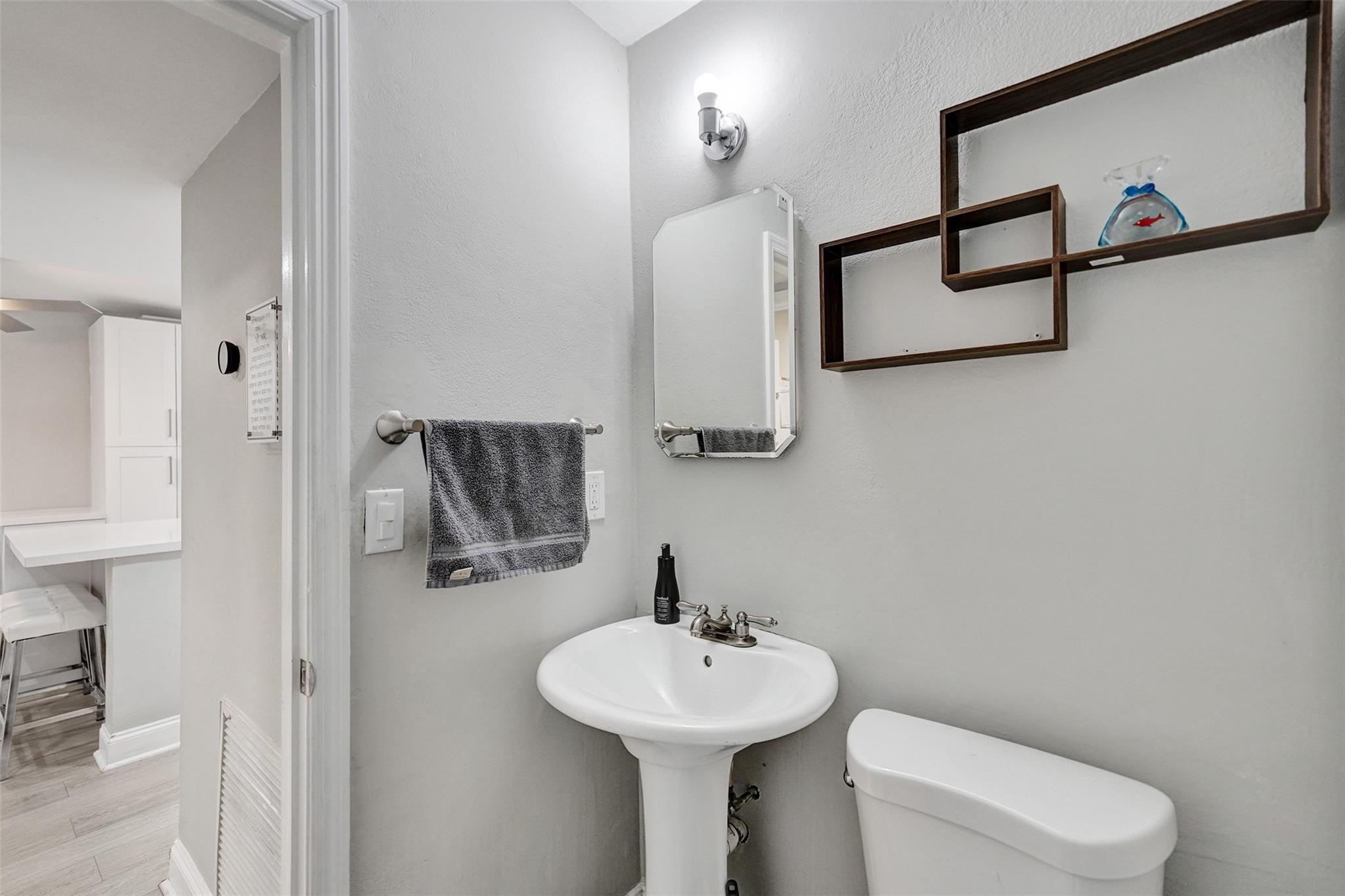 3301 Raleigh Street, Unit 4B Hollywood, FL 33021 - Photo 24 of 54 a bathroom with a sink a toilet and mirror