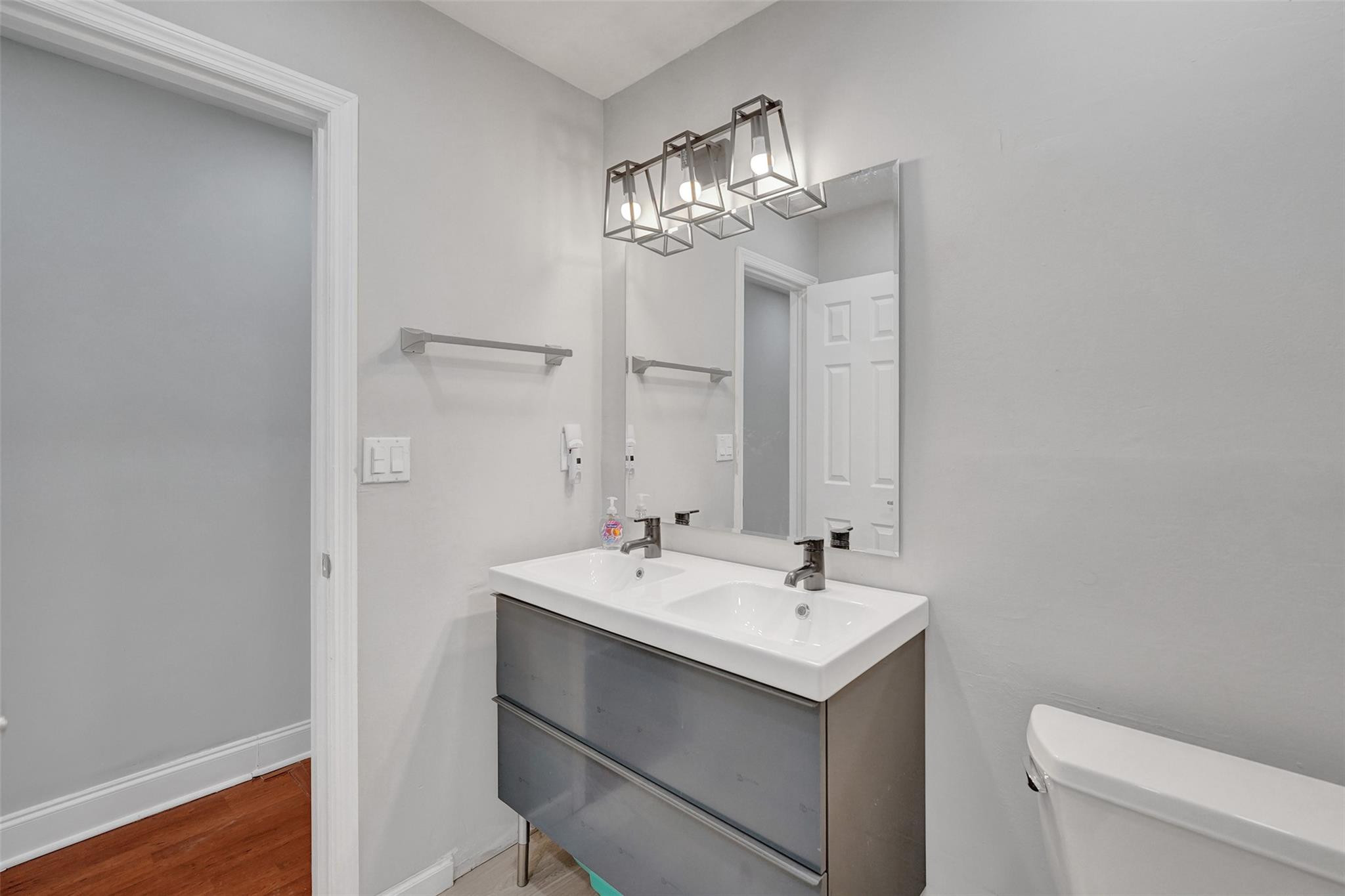 3301 Raleigh Street, Unit 4B Hollywood, FL 33021 - Photo 34 of 54 a bathroom with a sink a toilet and a mirror