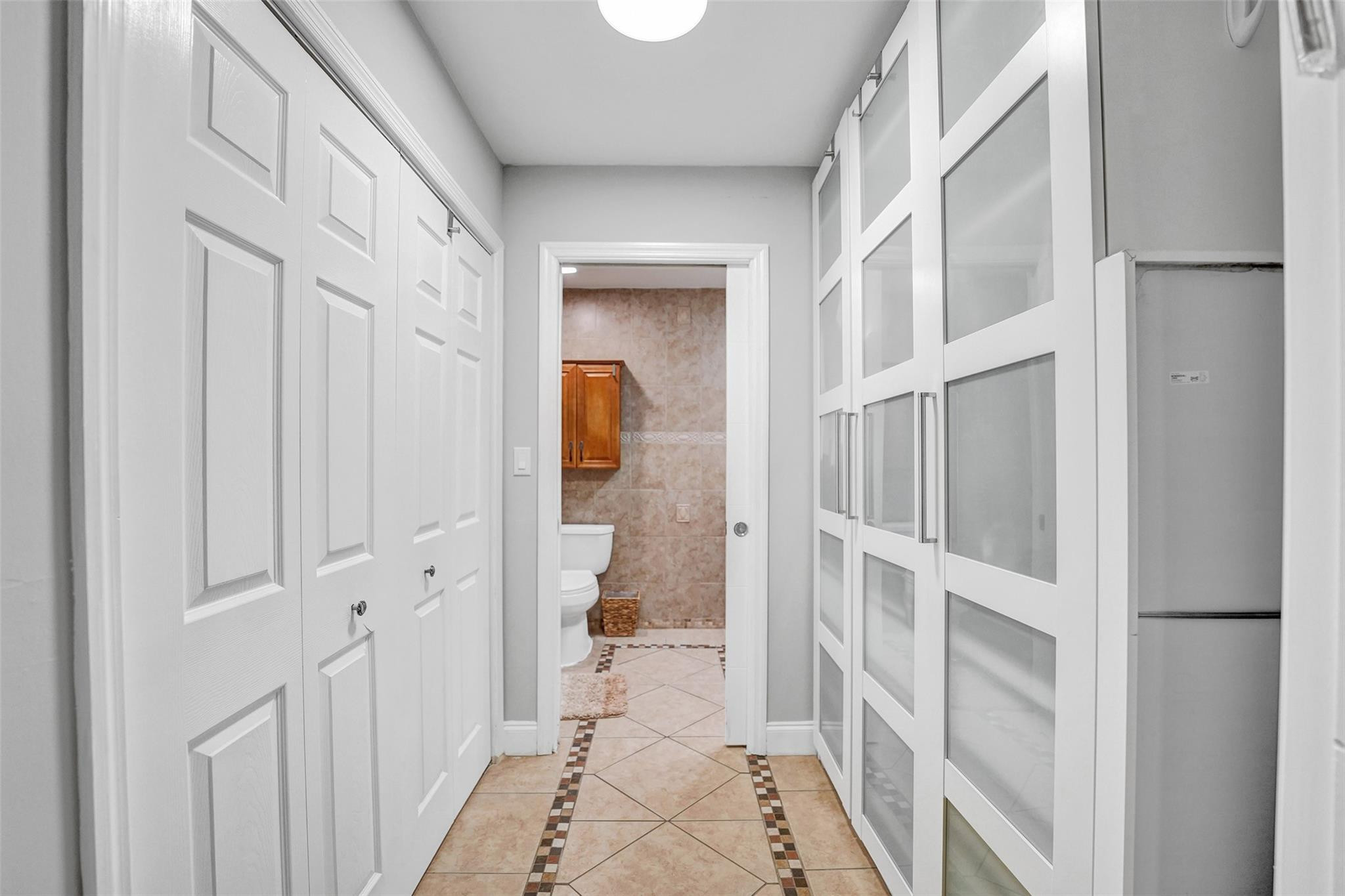 3301 Raleigh Street, Unit 4B Hollywood, FL 33021 - Photo 45 of 54 a view of a hallway with a hardwood floor and a bathroom