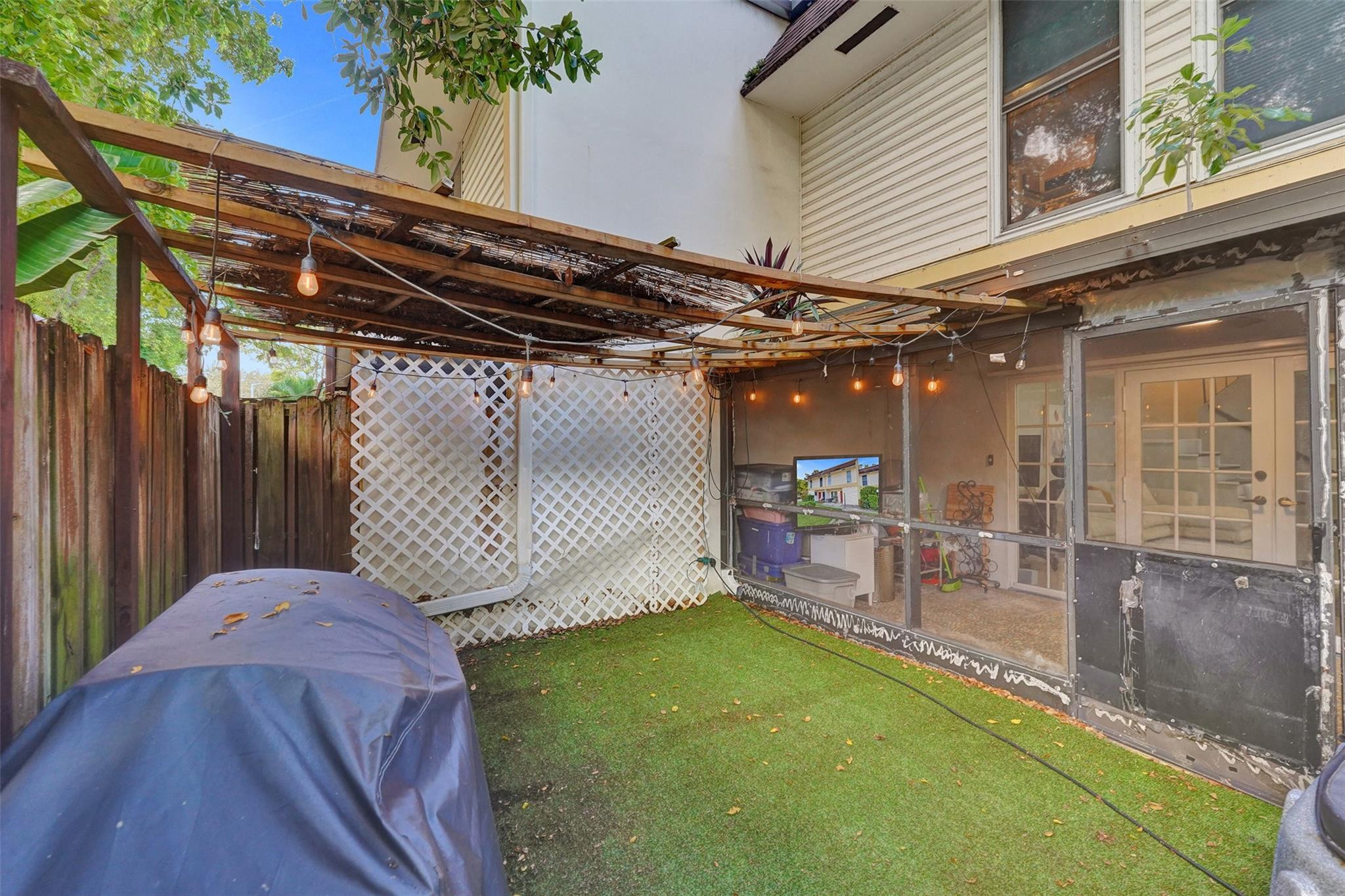 3301 Raleigh Street, Unit 4B Hollywood, FL 33021 - Photo 53 of 54 a backyard of a house with table and chairs